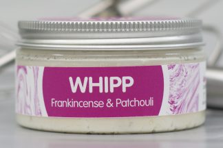 Jar of Frankincense & Patchouli Whipp on light metallic background