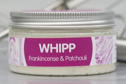 Jar of Frankincense & Patchouli Whipp on light metallic background